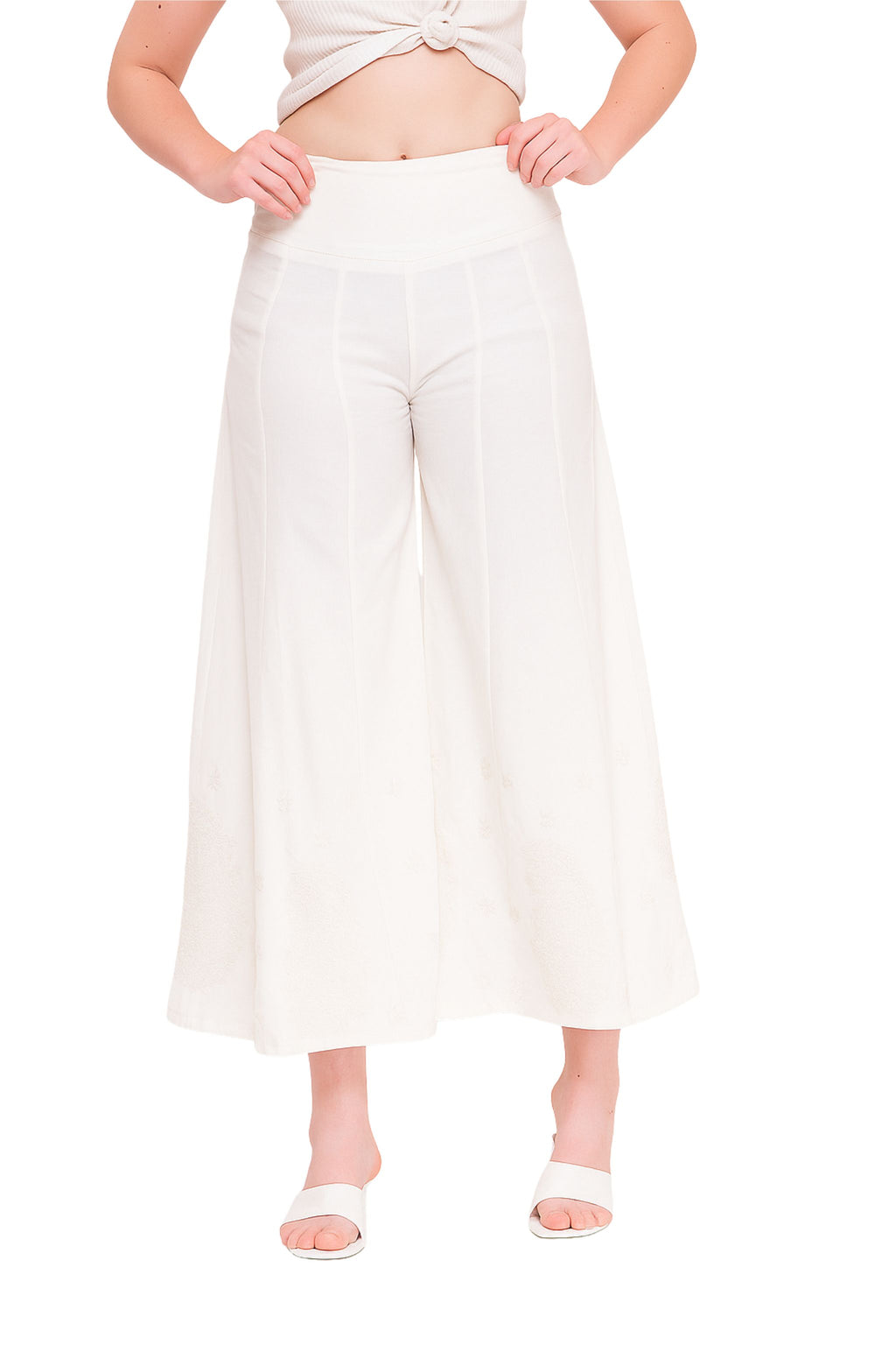 Person wearing white wide-leg pants on a white background