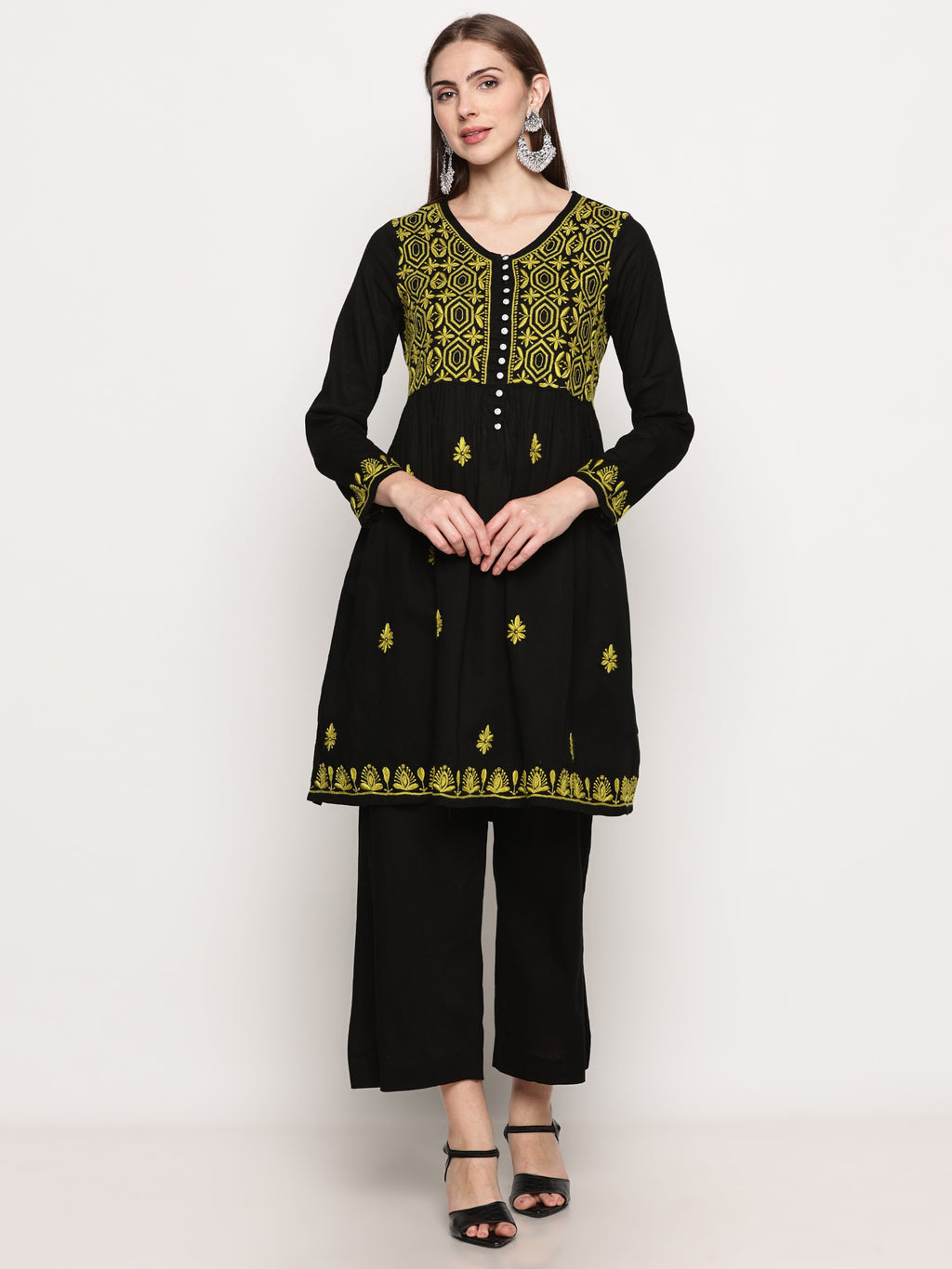 Model wearing a black pure cotton chikankari co-ord set featuring lime green hand embroidery with chana pattai, ulti bakhiya, phanda, keel, and pechni stitches, V-neck, and full sleeves.