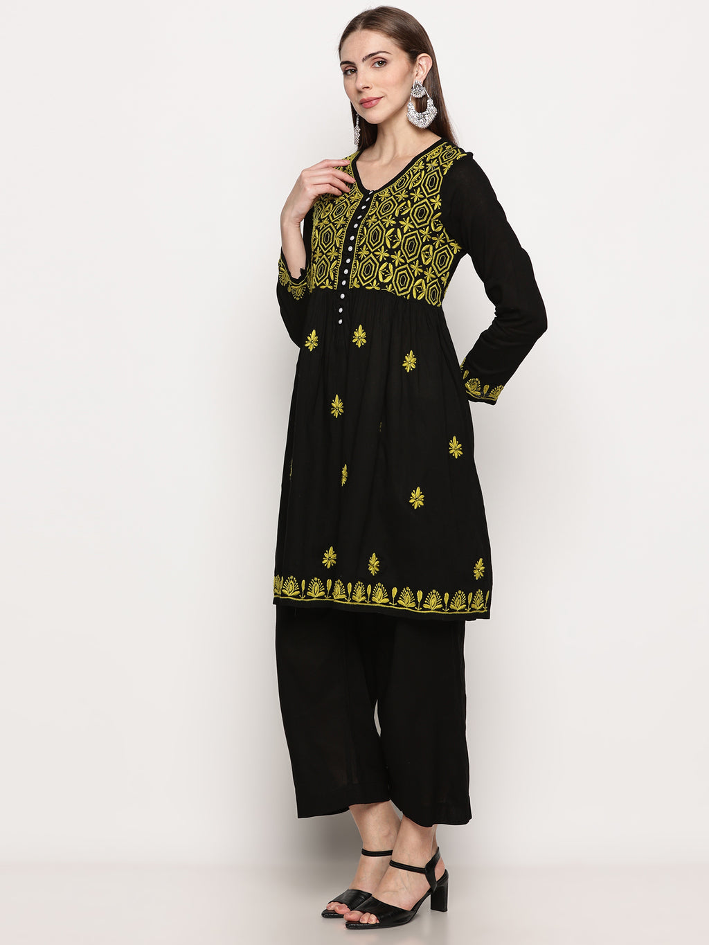 Model wearing a black pure cotton chikankari co-ord set featuring lime green hand embroidery with chana pattai, ulti bakhiya, phanda, keel, and pechni stitches, V-neck, and full sleeves.