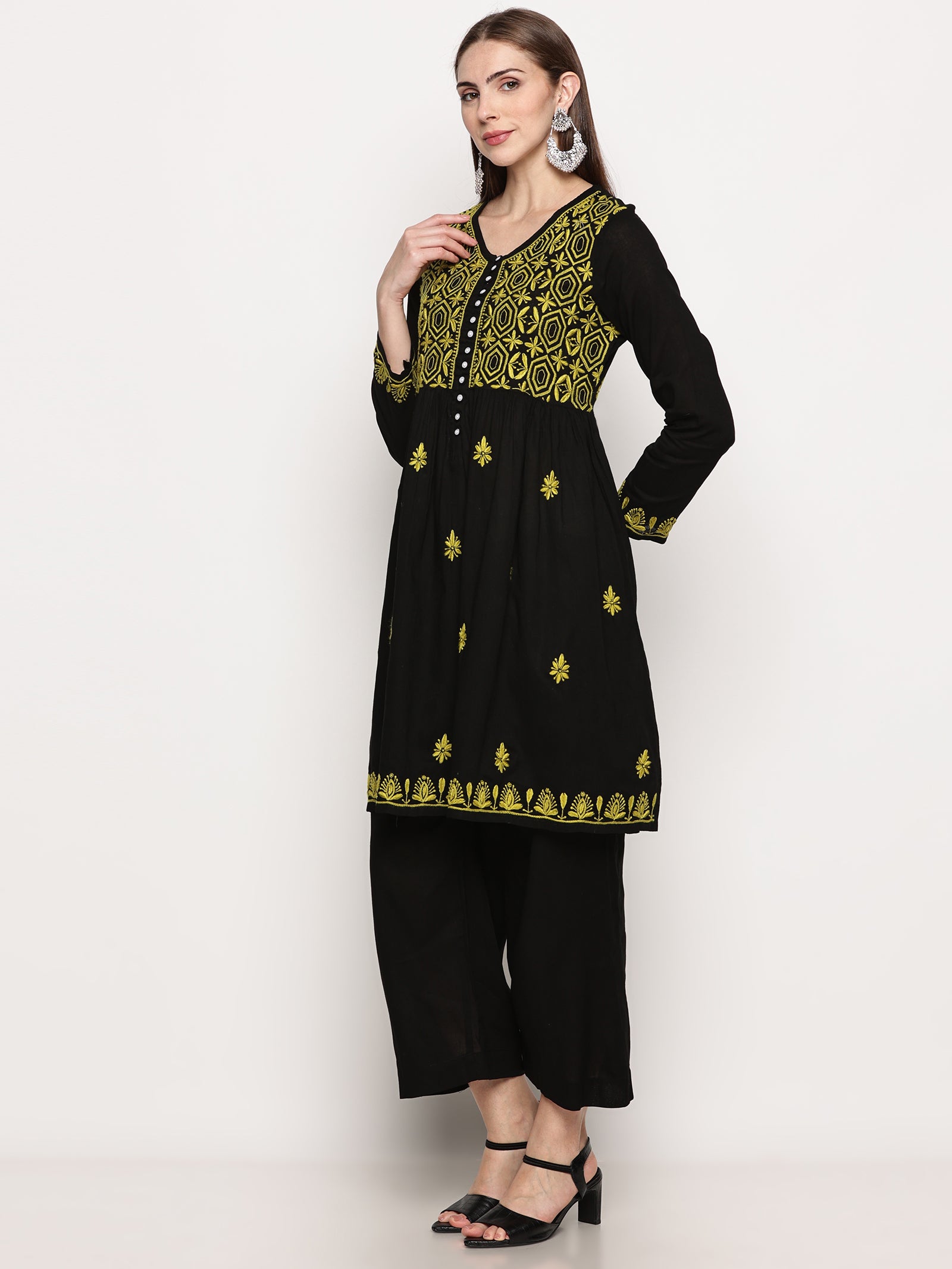 Model wearing a black pure cotton chikankari co-ord set featuring lime green hand embroidery with chana pattai, ulti bakhiya, phanda, keel, and pechni stitches, V-neck, and full sleeves.
