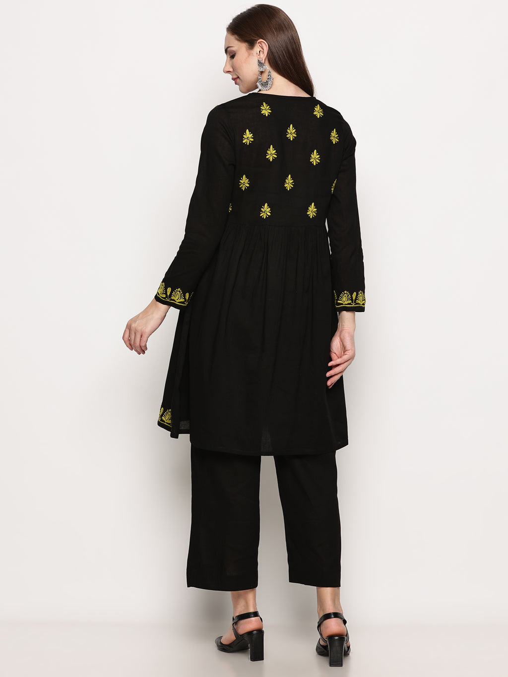 Model wearing a black pure cotton chikankari co-ord set featuring lime green hand embroidery with chana pattai, ulti bakhiya, phanda, keel, and pechni stitches, V-neck, and full sleeves.