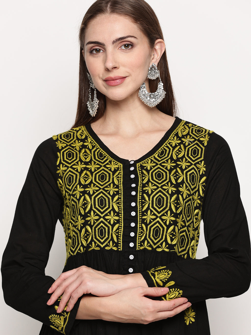 Model wearing a black pure cotton chikankari co-ord set featuring lime green hand embroidery with chana pattai, ulti bakhiya, phanda, keel, and pechni stitches, V-neck, and full sleeves.