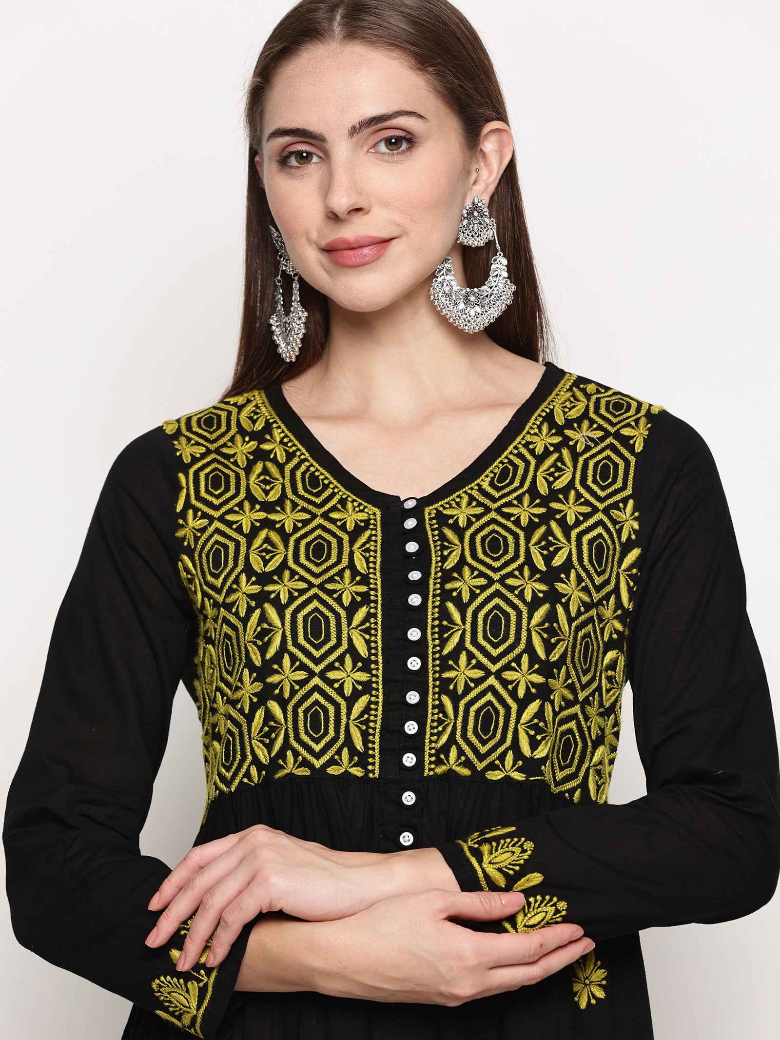 Model wearing a black pure cotton chikankari co-ord set featuring lime green hand embroidery with chana pattai, ulti bakhiya, phanda, keel, and pechni stitches, V-neck, and full sleeves.