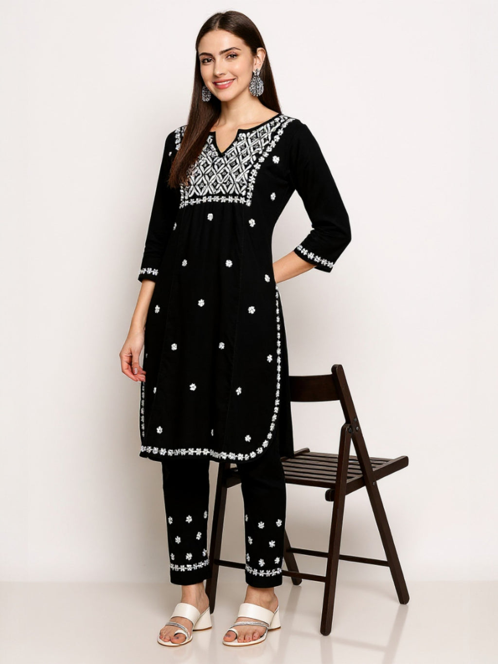 Black A woman wearing a  kurta with  embroidery and polka dots on a background Black
