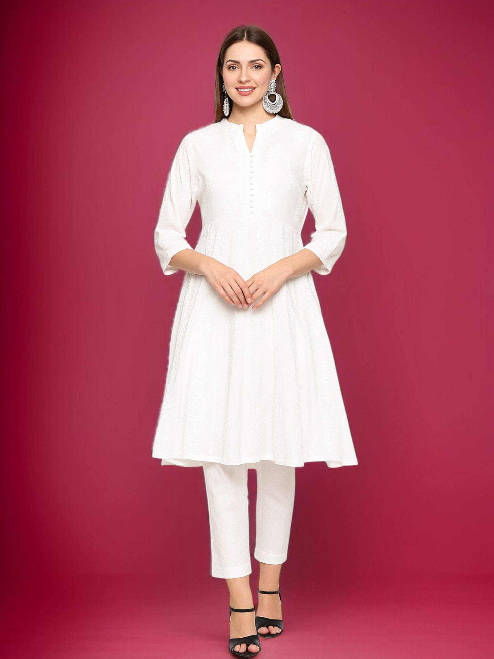 Woman wearing a white outfit against a pink background